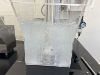 Water-filled acrylic flotation cell in operation with AISI 316 stainless steel agitation mechanism, compatible with D-12 type test procedures