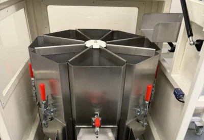 Detail view of fixed sample collection containers inside rotary sample divider