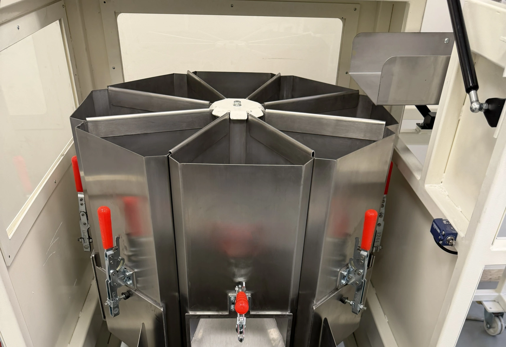 Detail view of fixed sample collection containers inside rotary sample divider